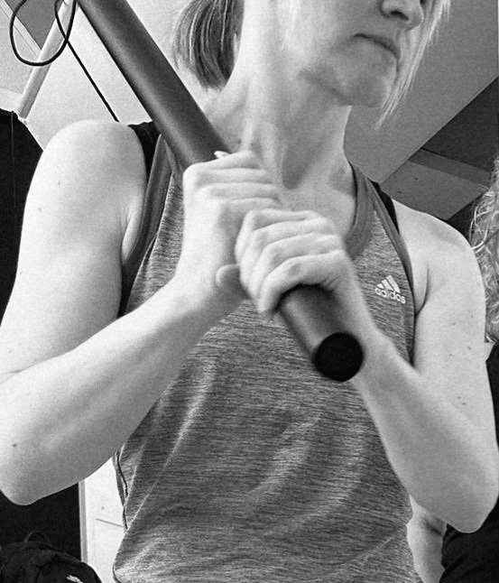 Woman holding stick for rage release class